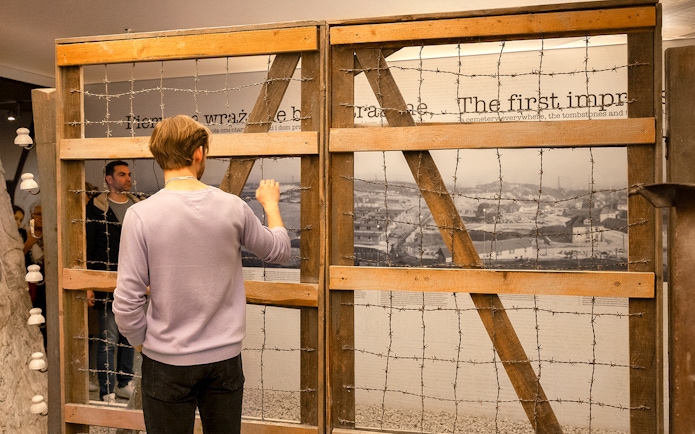 Visitor examining exhibit at Oskar Schindler’s Factory in Krakow.