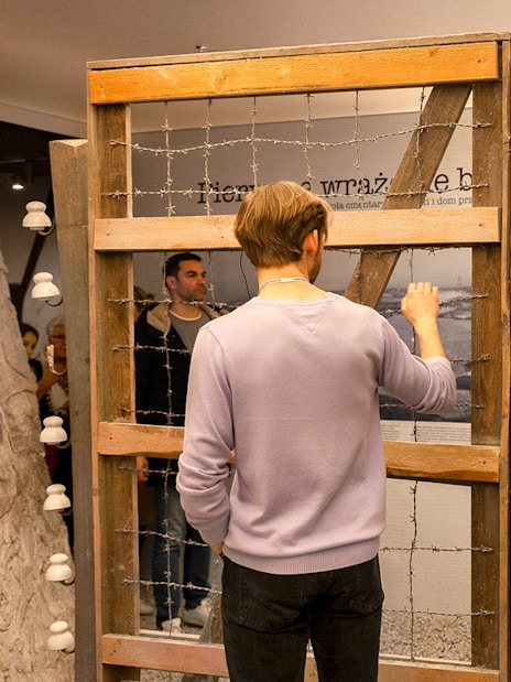 Visitor examining exhibit at Oskar Schindler’s Factory in Krakow.