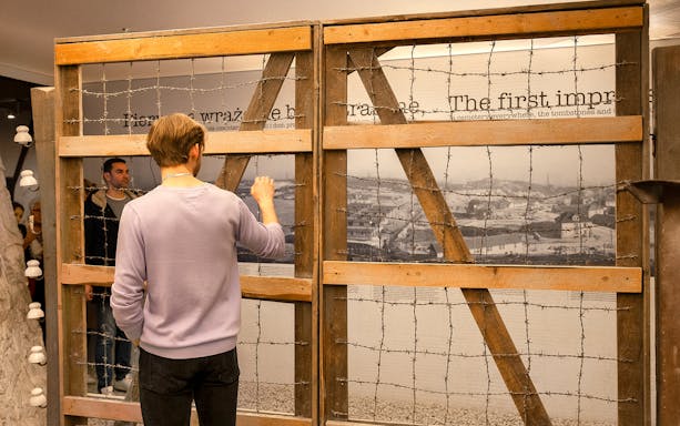 Visitor examining exhibit at Oskar Schindler’s Factory in Krakow.