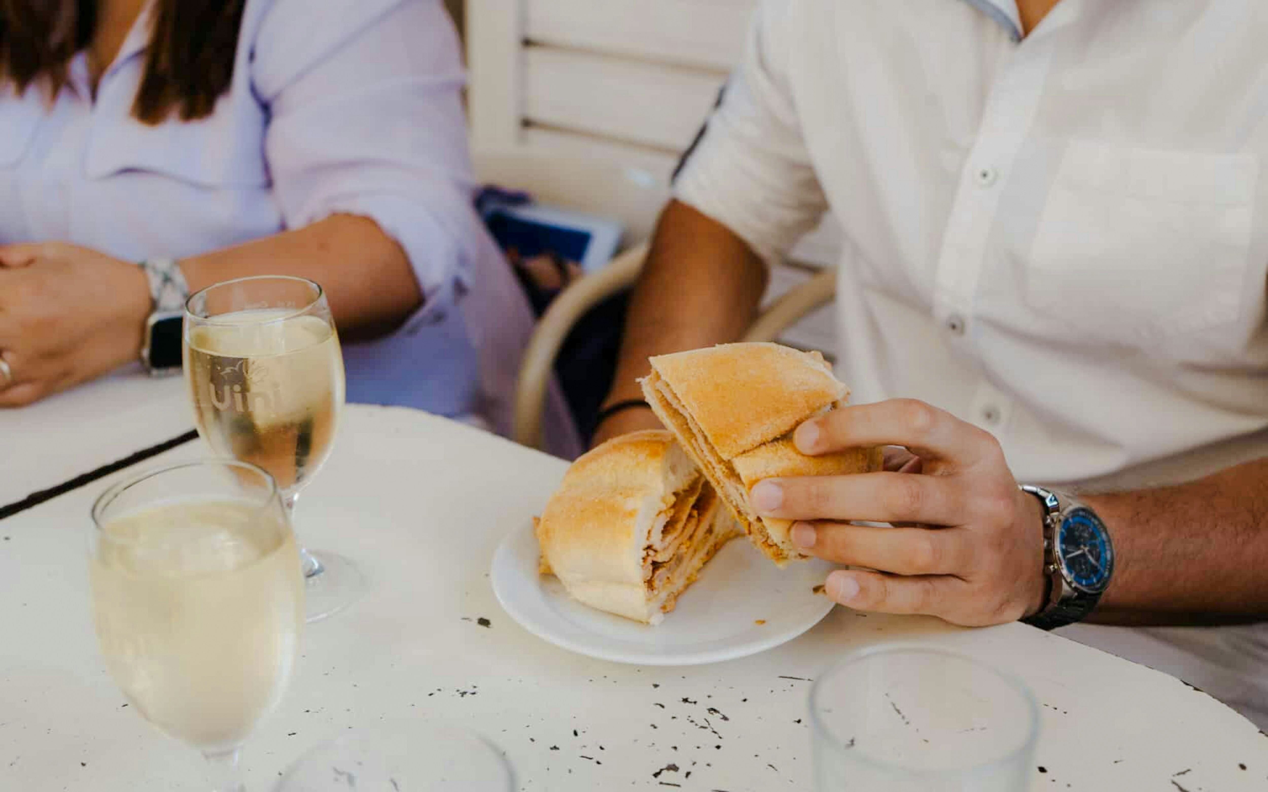 Person enjoying bifana sandwich on Lisbon Food Tour in Portugal.