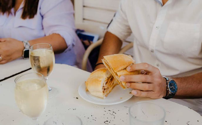 Person holding a bifana sandwich on Lisbon Food Tour.