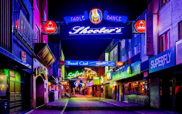 Neon-lit street in St. Pauli, Hamburg, featuring bars and clubs for the Sex & Crime Tour.
