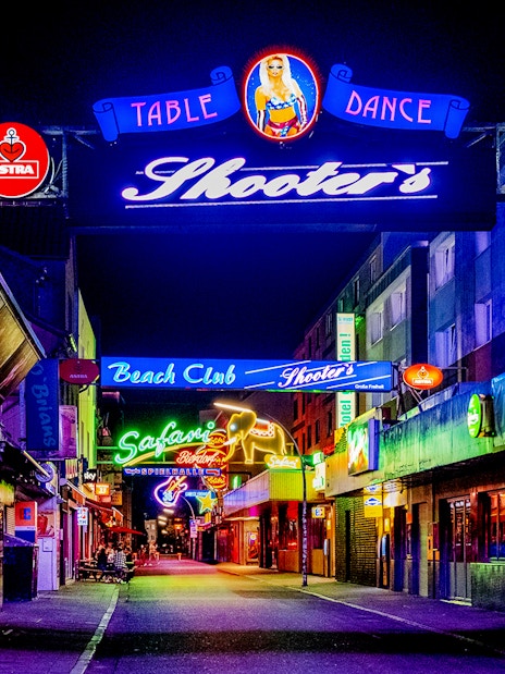 Neon-lit street in St. Pauli, Hamburg, featuring bars and clubs for the Sex & Crime Tour.