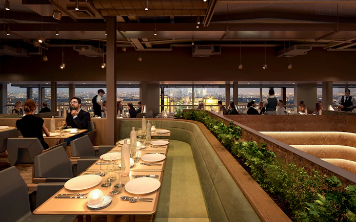Dining area inside Eiffel Tower's Madame Brasserie with city view.