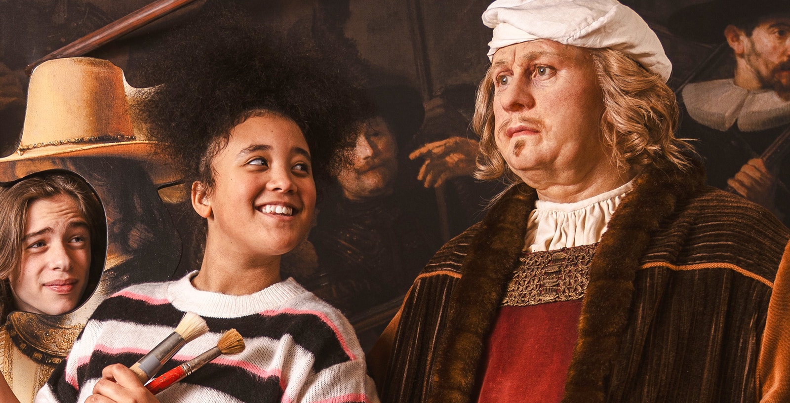 Visitors interacting with Rembrandt wax figure at Madame Tussauds Amsterdam.