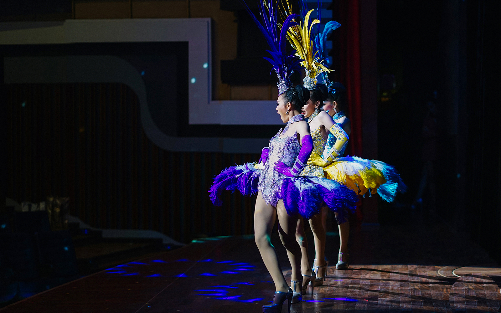 Performers in colorful costumes on stage at Alcazar Cabaret Show, Pattaya.