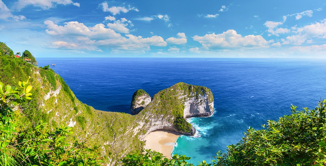 Scenic view of Kelingking Beach on West Nusa Penida Island with cliffs and ocean.