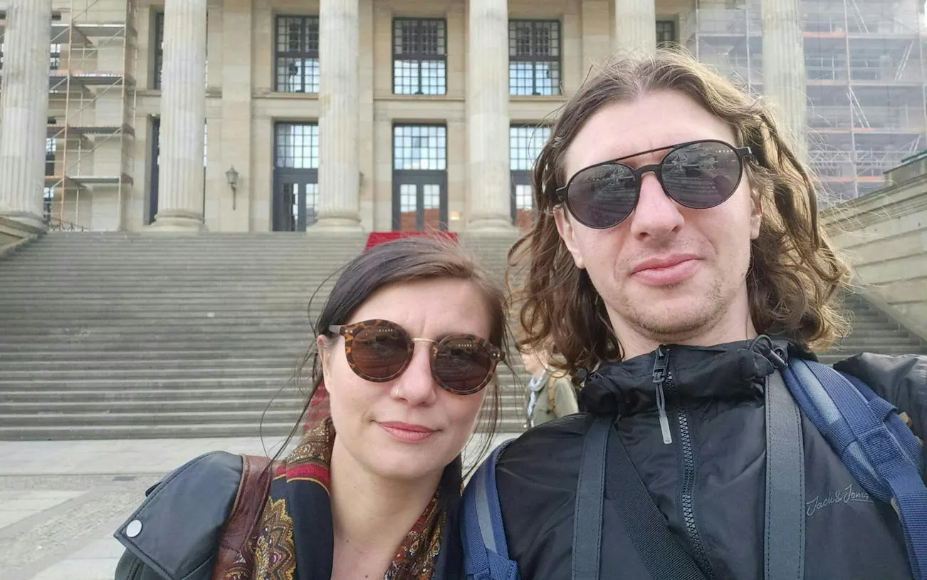 Couple in front of Berlin concert hall during self-guided city exploration game.