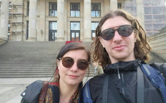 Couple in front of Berlin concert hall during self-guided city exploration game.