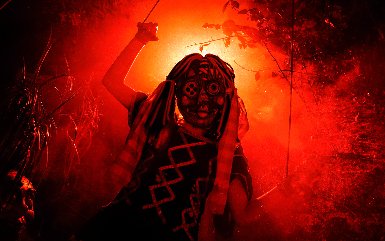 Person in a tribal mask and costume at Halloween event in Thorpe Park.
