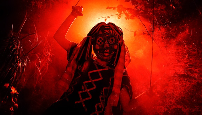 Person in a tribal mask and costume at Halloween event in Thorpe Park.