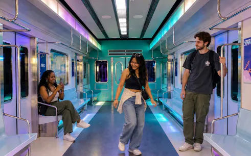 Guests enjoying K-POP Fan Tour in Seoul subway-themed setting.