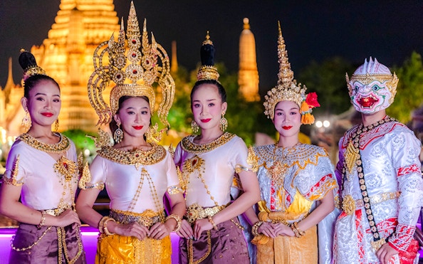 Performers in traditional Thai costumes on Bangkok Chao Phraya dinner cruise.