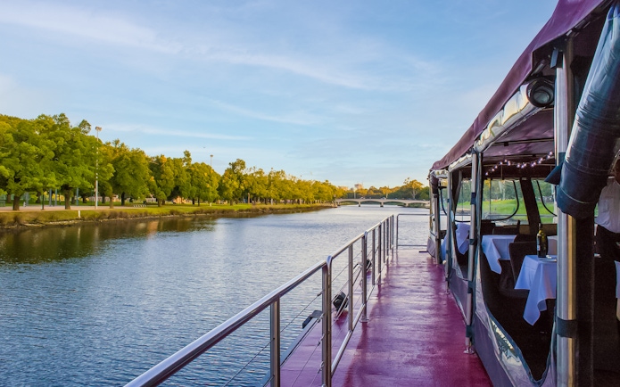 Cruise boat on Yarra River in Melbourne with tables set for brunch.