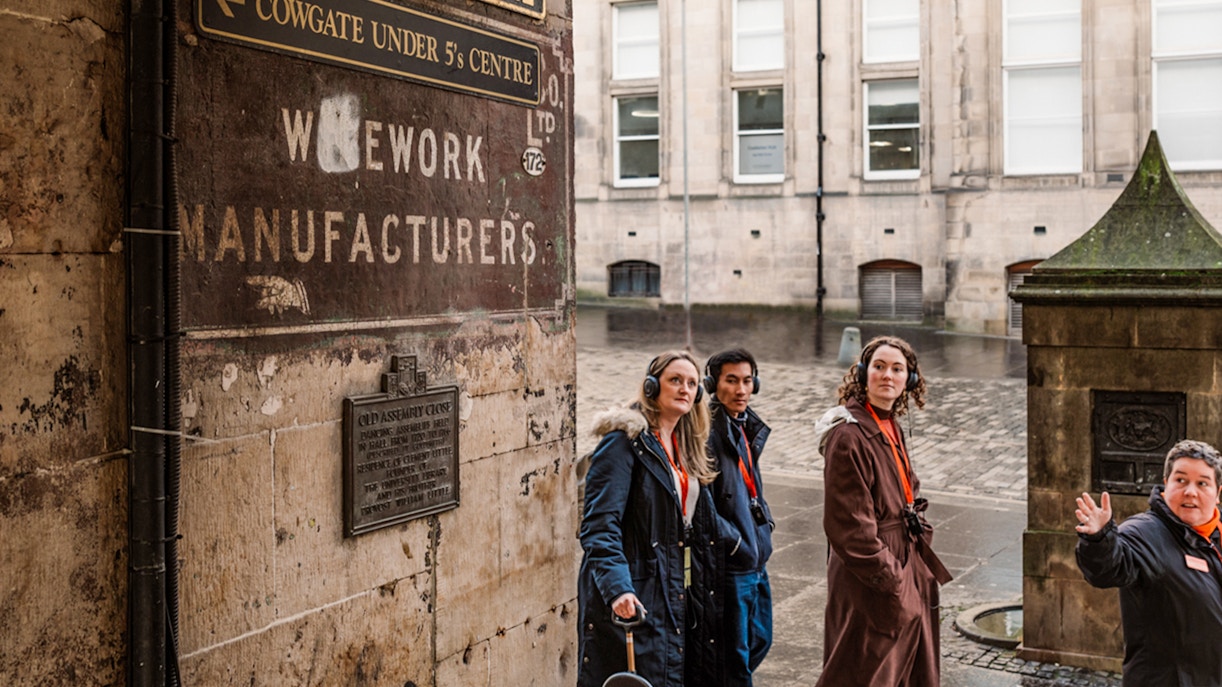 Guide leading guests through Edinburgh's Historic Underground Vaults.