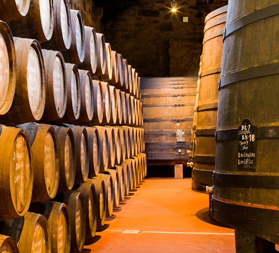 Barrels aging wine in Calem Caves, Porto, Portugal.