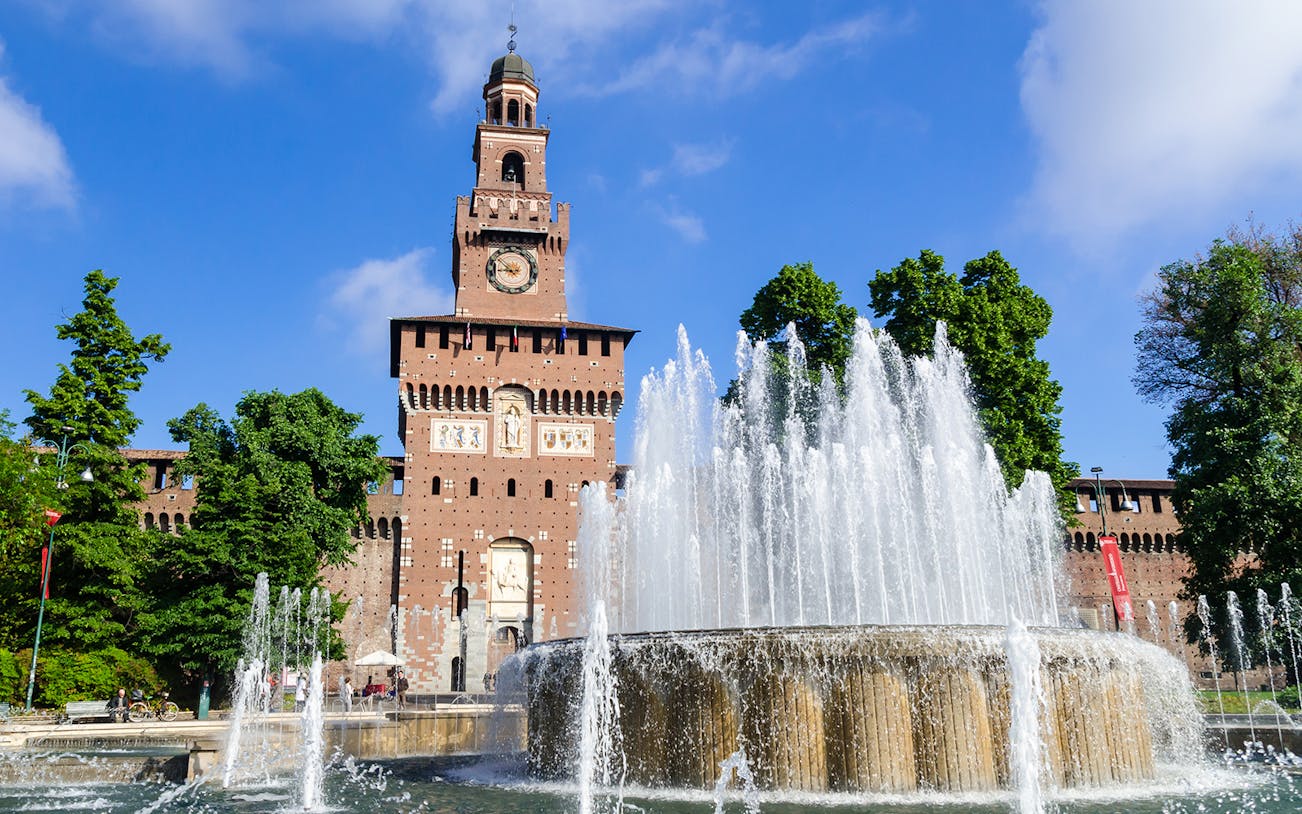 Sforza Castle in Milan with fountain in foreground.
