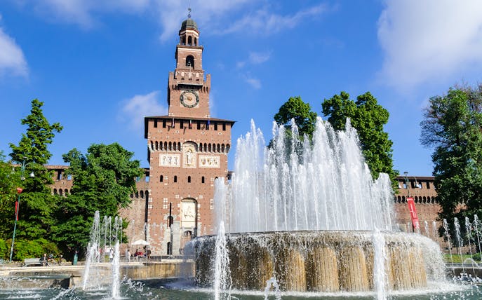 Sforza Castle in Milan with fountain in foreground.