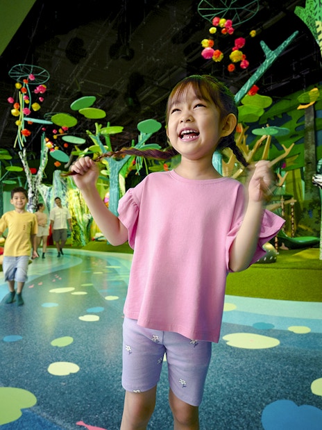 Children playing at Curiosity Cove Main Entrance with colorful indoor playground.