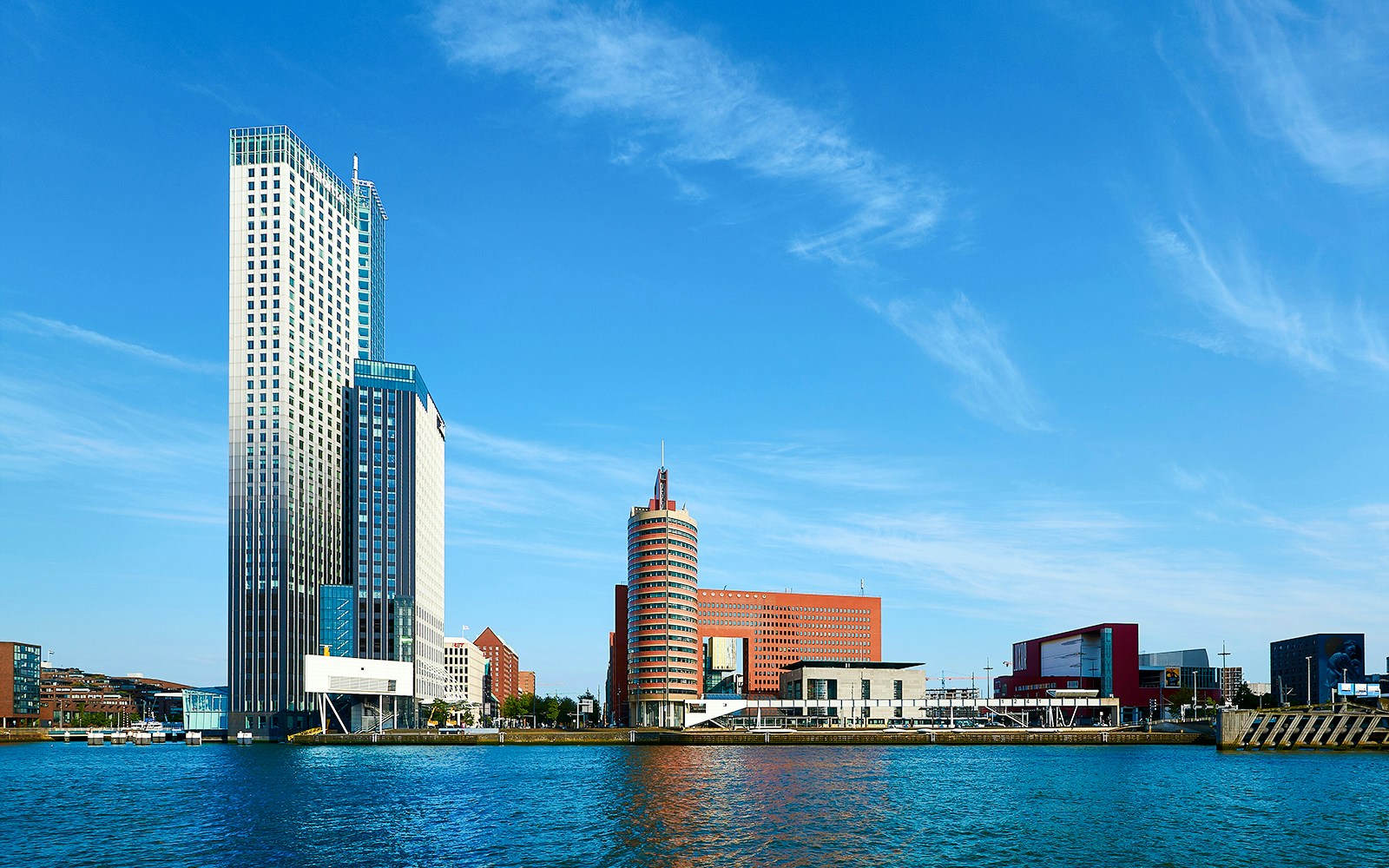 Maastoren skyscraper and surrounding buildings along the waterfront in Rotterdam, Netherlands.