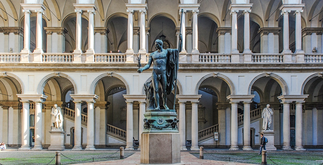 Statue of Napoleon as Mars the Peacemaker in a courtyard, with the Pinacoteca di Brera building in the background.