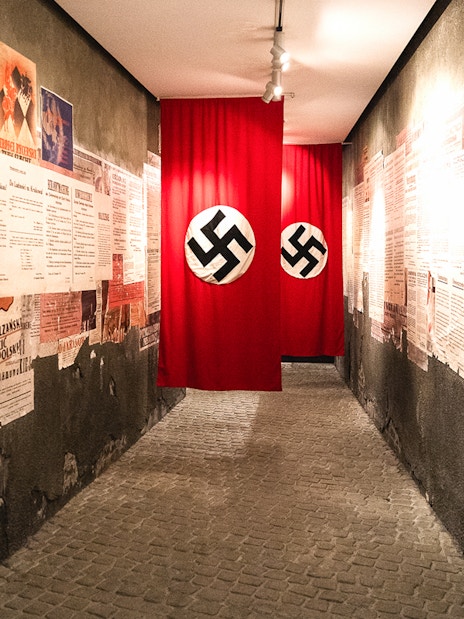 Hallway with historical posters and Nazi flags inside Oskar Schindler's Factory, Krakow.