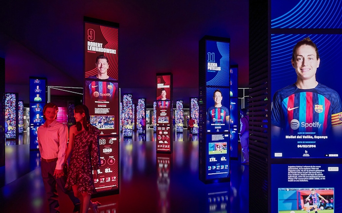 FC Barcelona museum exhibit with digital displays of players, part of immersive tour experience.