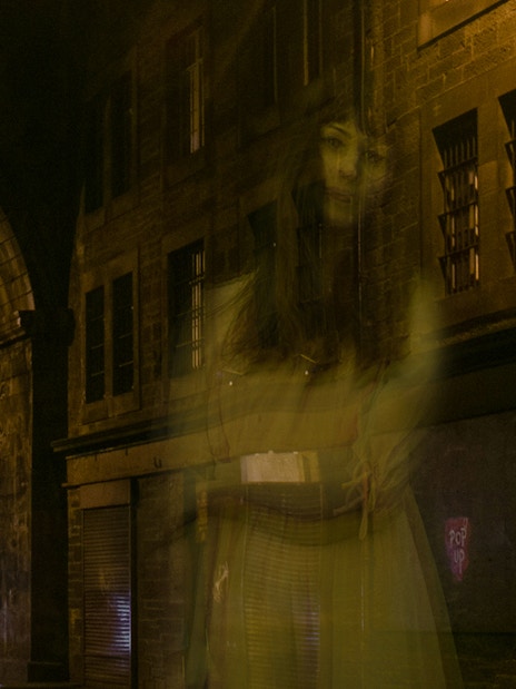 Ghostly figure in a dimly lit alley during Extreme Paranormal Activity Tour.