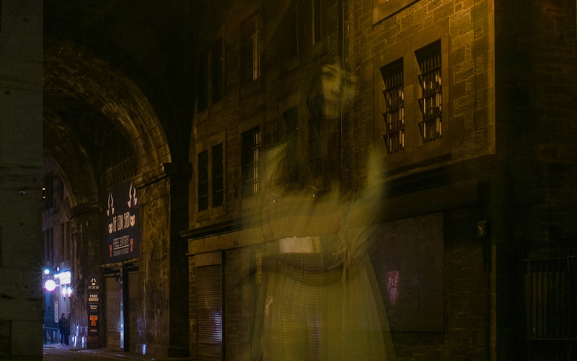 Ghostly figure in a dimly lit alley during Extreme Paranormal Activity Tour.