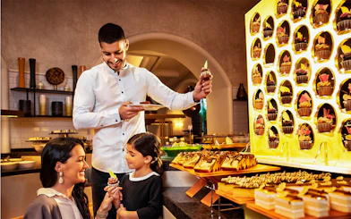 Family enjoying dessert at Atlantis the Palm buffet near Ambassador Lagoon Aquarium.