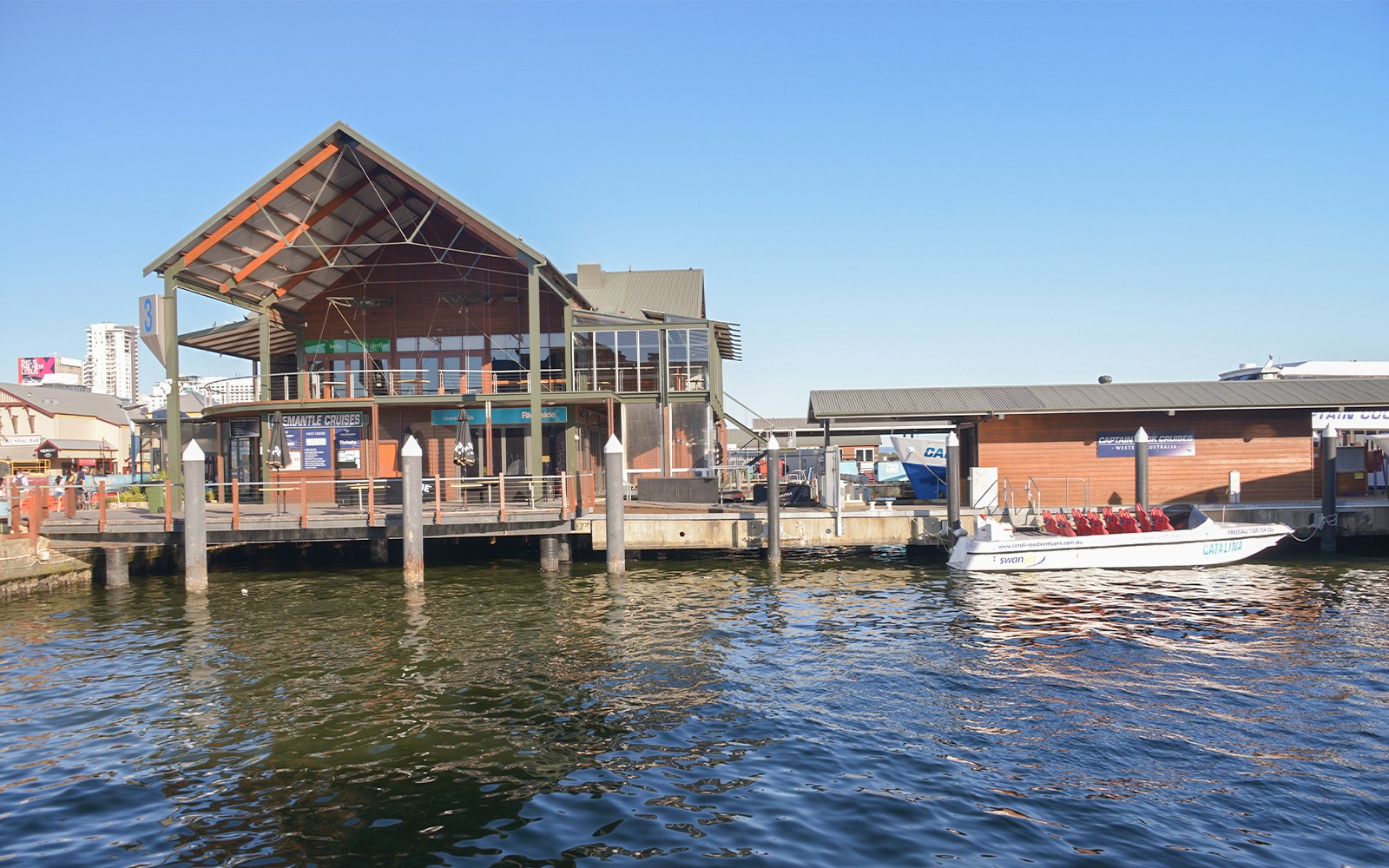 Barrack Street Jetty Terminal with docked tour boats in Perth, Australia.