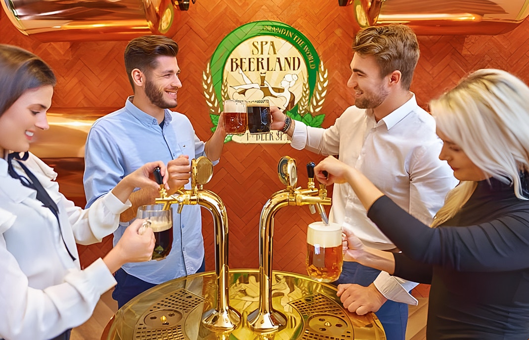 Group of friends drinking beer from a beer fountain at Spa Beerland in Prague