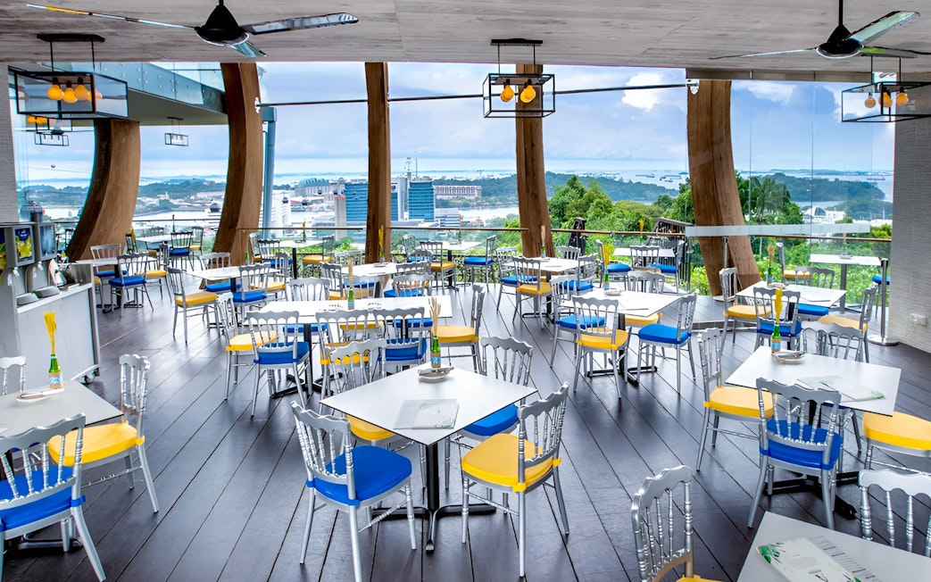 Aerial view from Singapore Cable Car restaurant with cityscape in the background.
