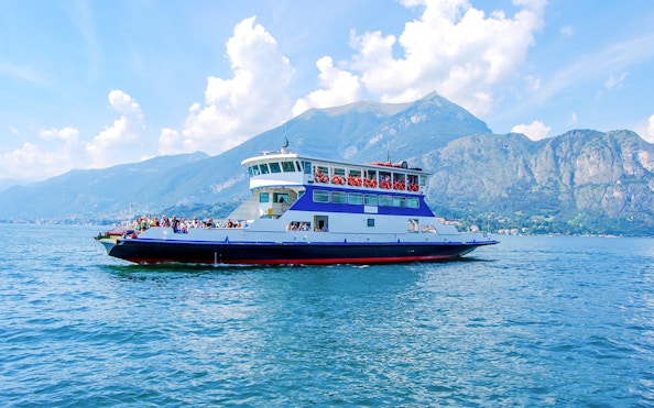 Cruise boat on Lake Como with views of Bellagio and surrounding mountains.