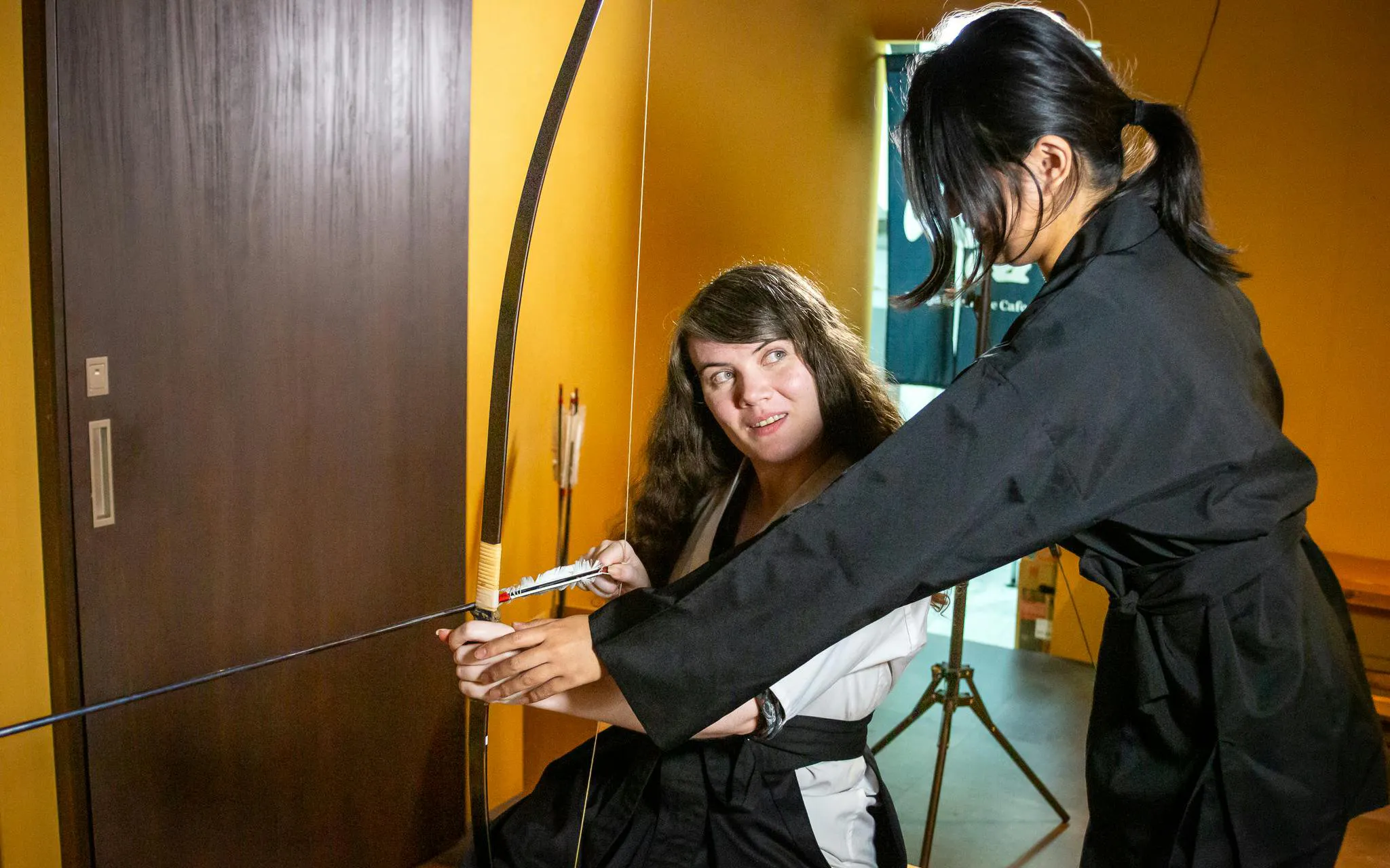 Two women practicing Japanese archery at 20-Arrow Experience in Kyoto.