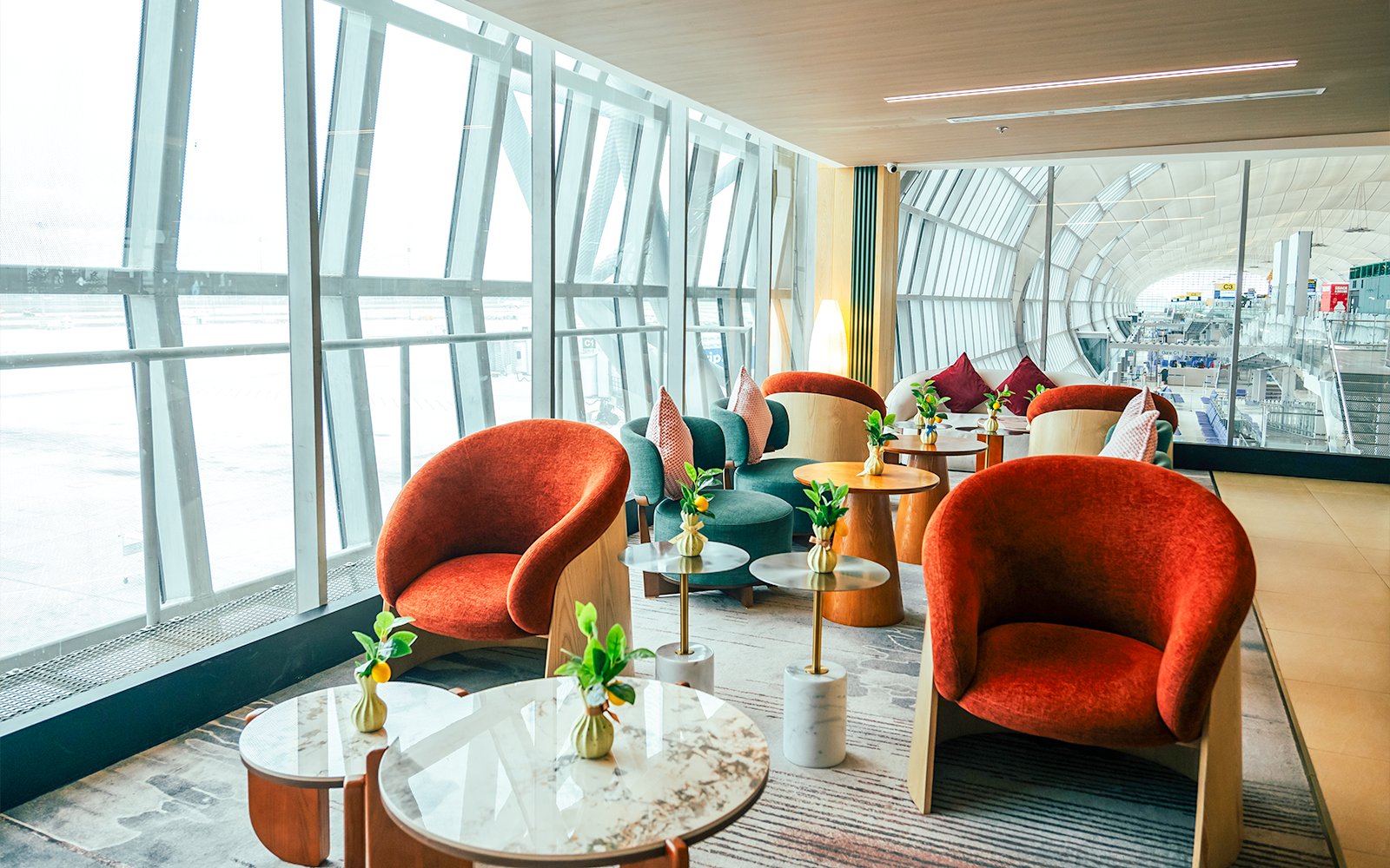 Coral Airport Lounge seating area at Suvarnabhumi Airport with modern chairs and tables.