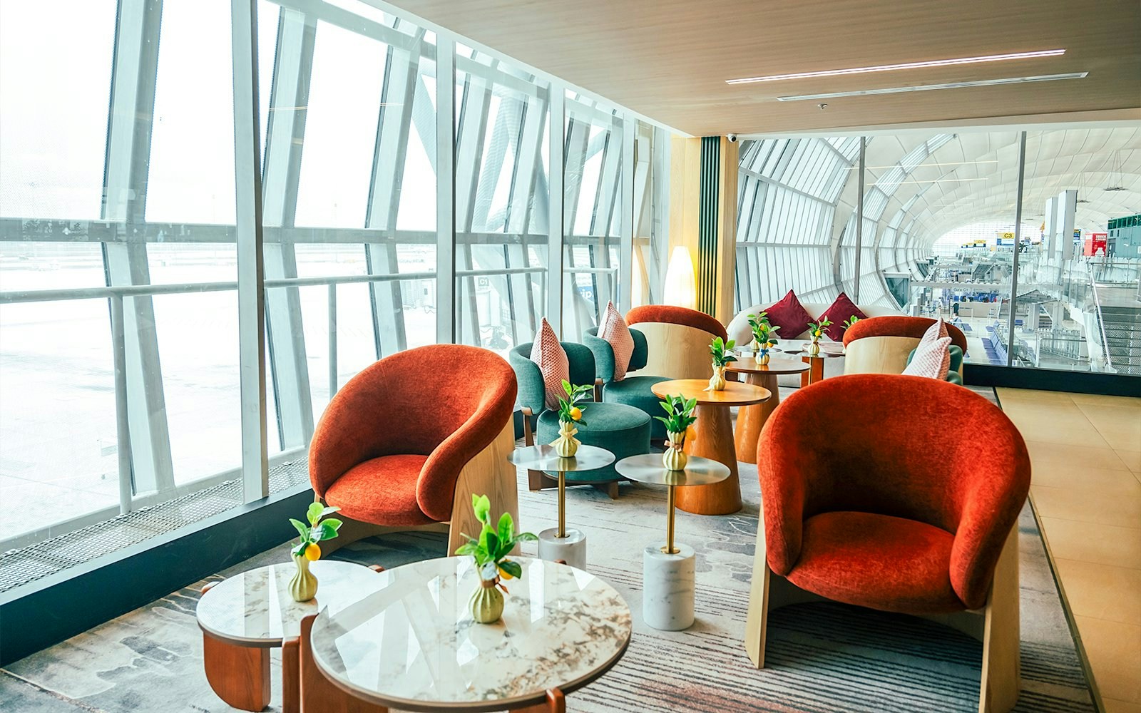 Coral Airport Lounge seating area at Suvarnabhumi Airport with modern chairs and tables.