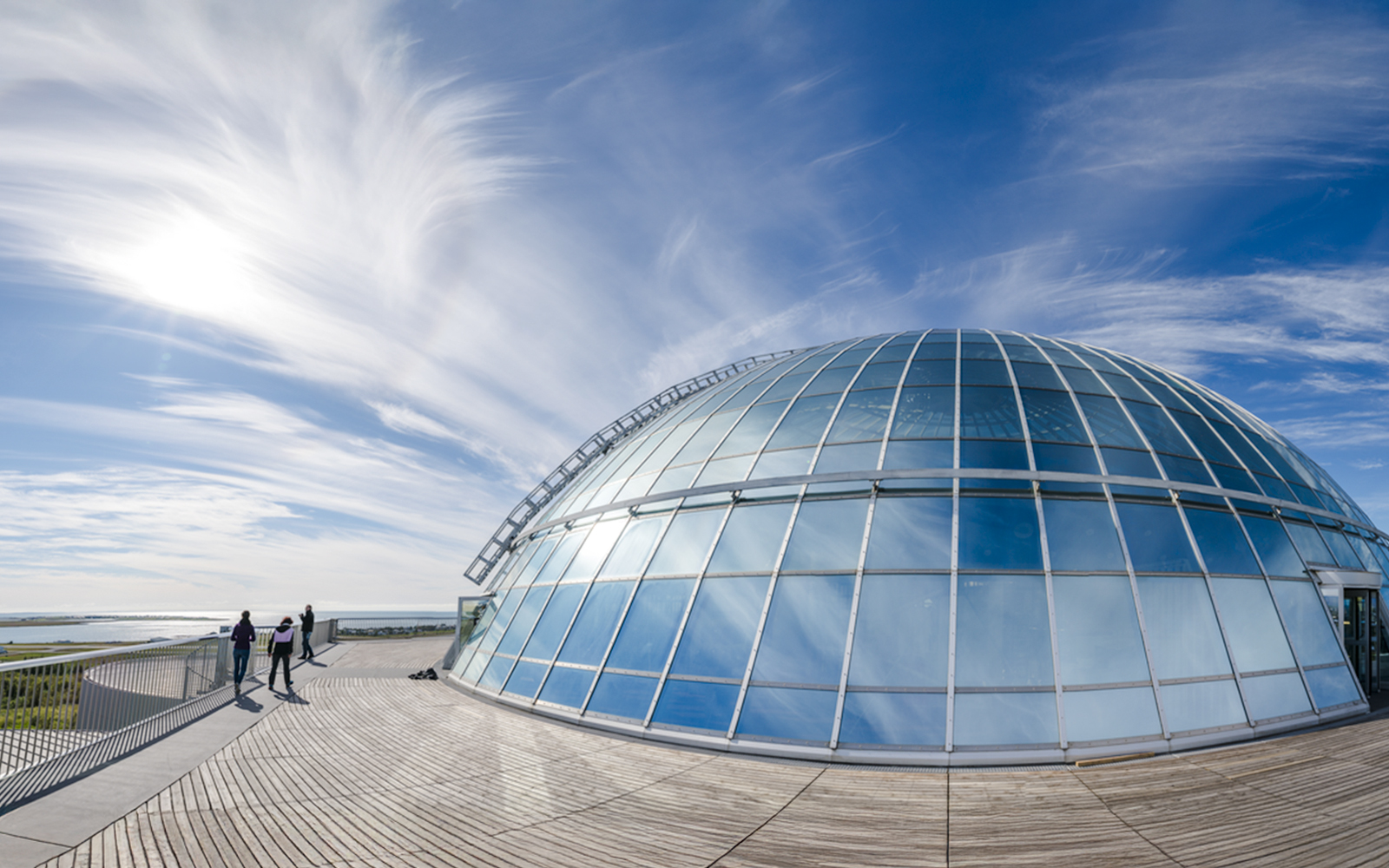 Perlan Museum's glass dome with visitors on the 360-degree observation deck in Reykjavik.