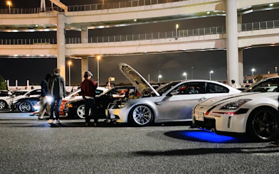 Cars gathered at Daikoku PA in Tokyo, showcasing local car culture at night.