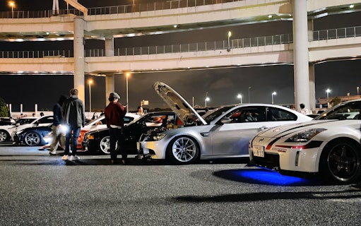 Cars gathered at Daikoku PA in Tokyo, showcasing local car culture at night.