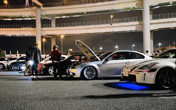 Cars gathered at Daikoku PA in Tokyo, showcasing local car culture at night.