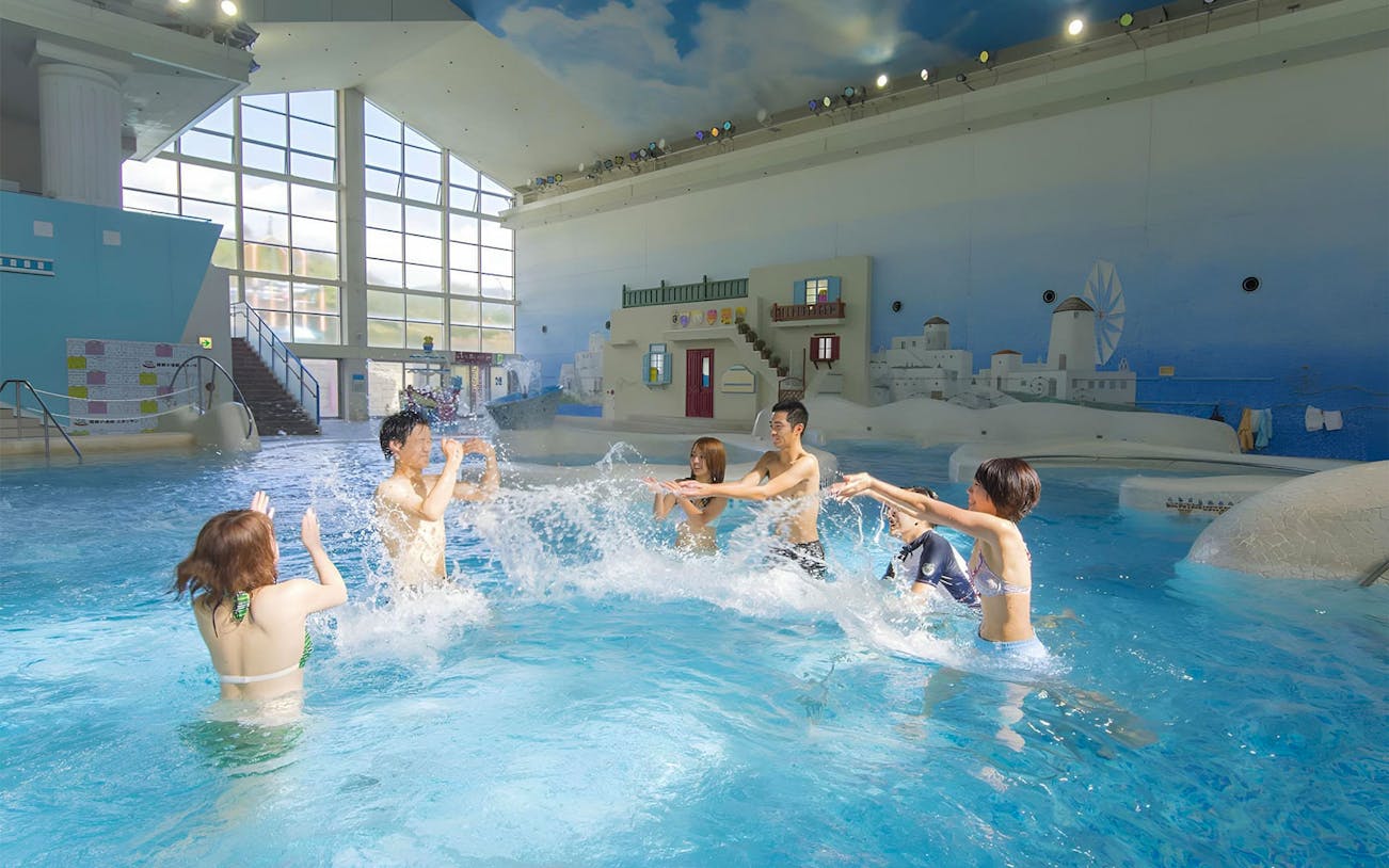 Visitors enjoying indoor pool at Hakone Kowakien Yunessun Hot Spring, Japan.