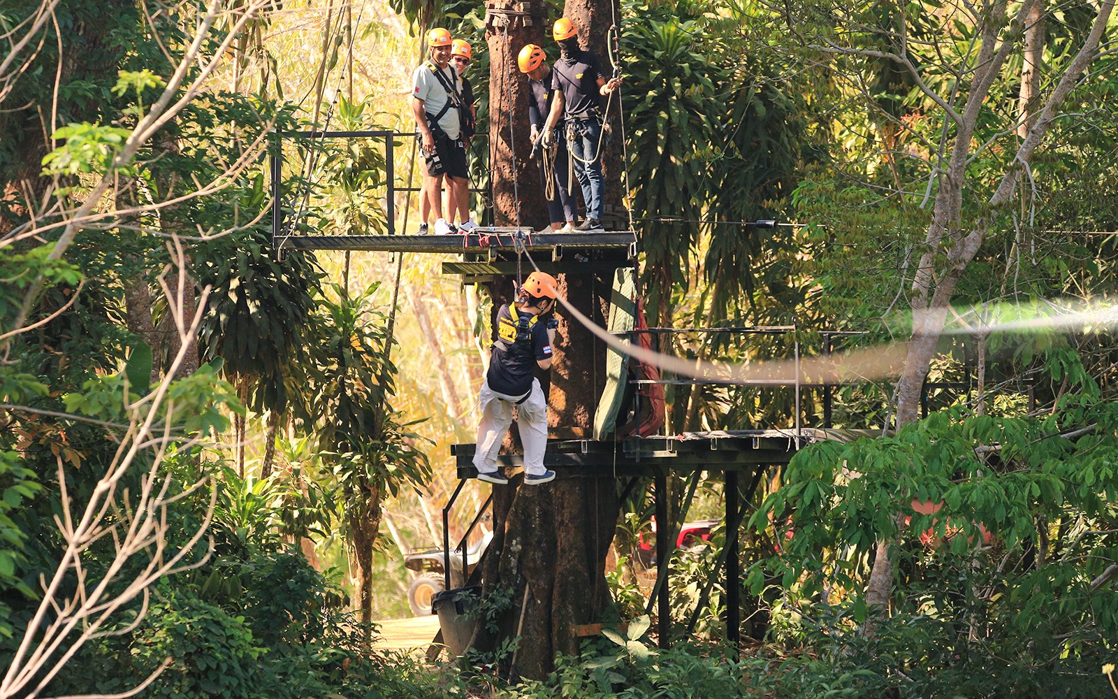 Participants preparing for a zipline adventure in the lush forest of Phuket Paradise.
