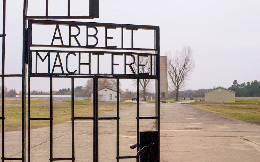 Entrance gate of Sachsenhausen Concentration Camp with "Arbeit Macht Frei" sign.