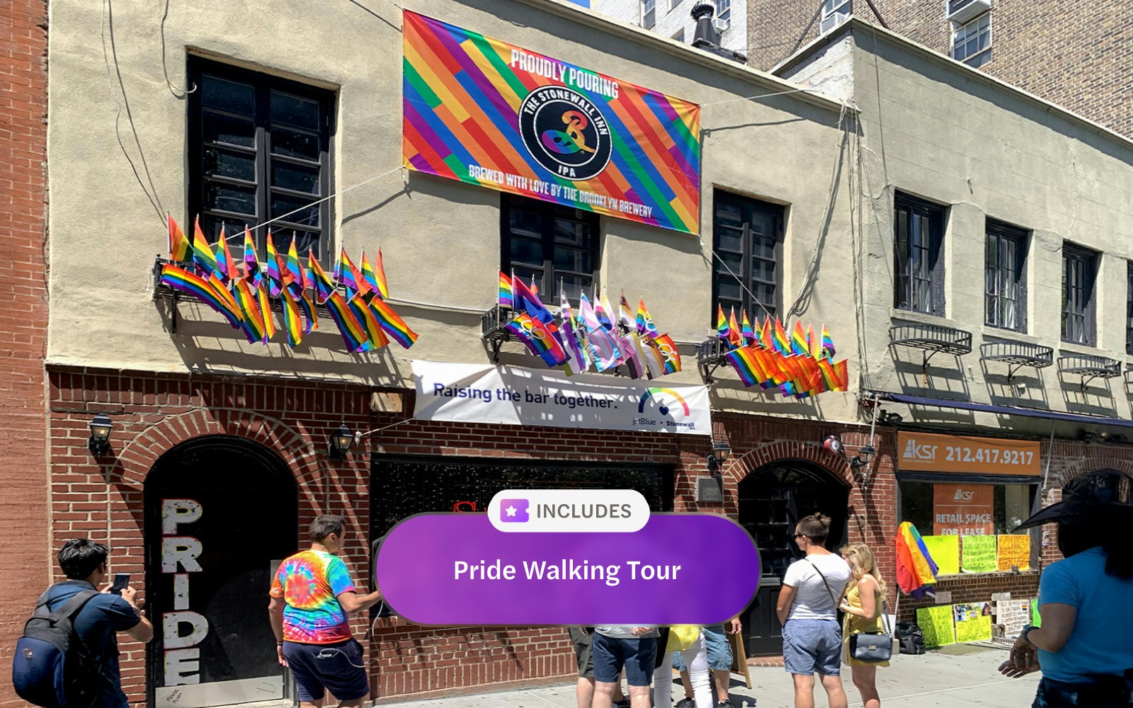 People walking with rainbow flags during the Go City New York Explorer Pass Pride Walking Tour.
