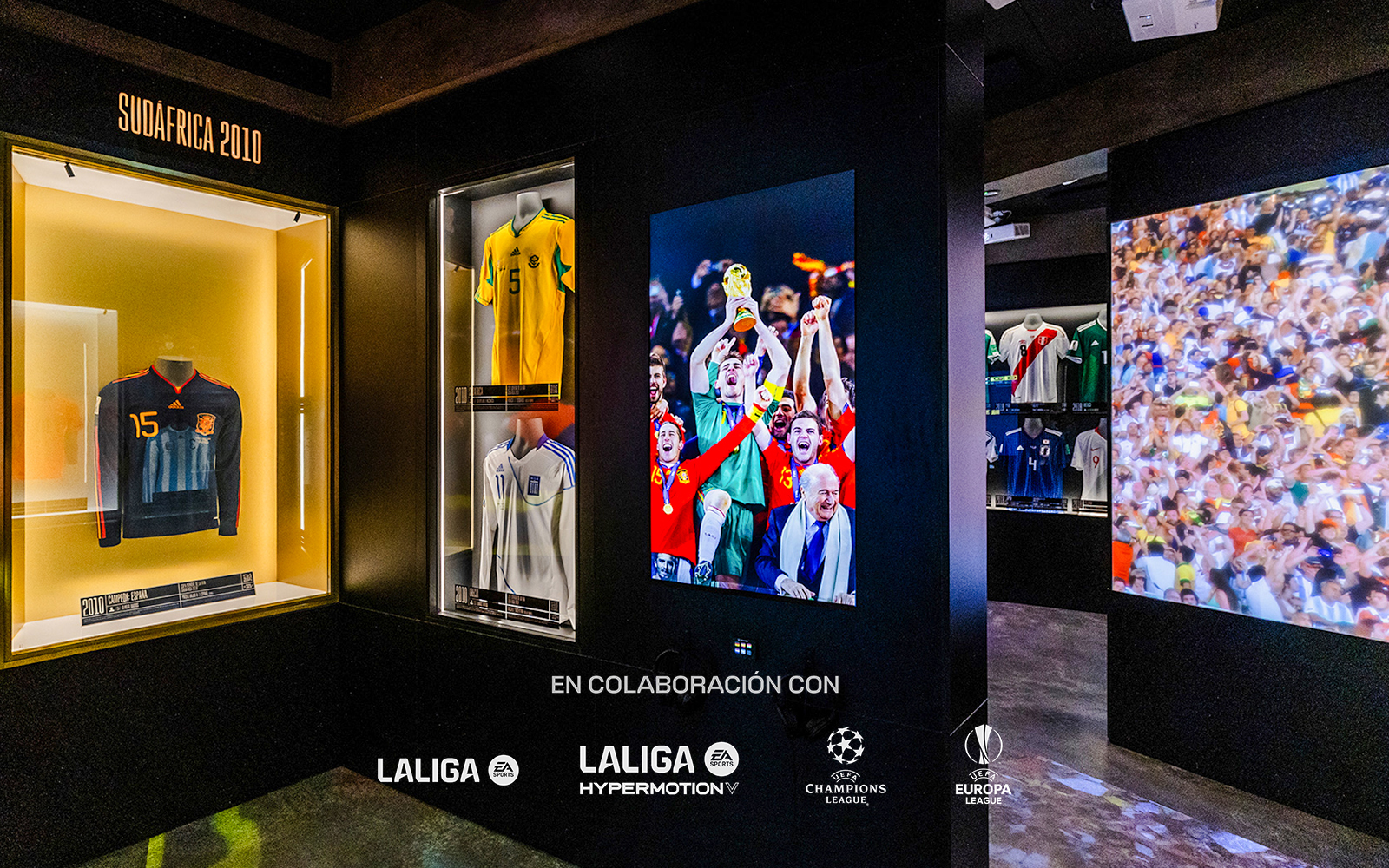Soccer jerseys and World Cup celebration photo in museum exhibit.