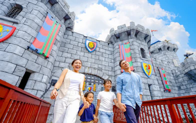 Family walking near castle at LEGOLAND Malaysia Theme Park.