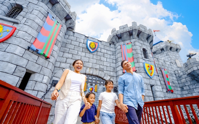 Family walking near castle at LEGOLAND Malaysia Theme Park.