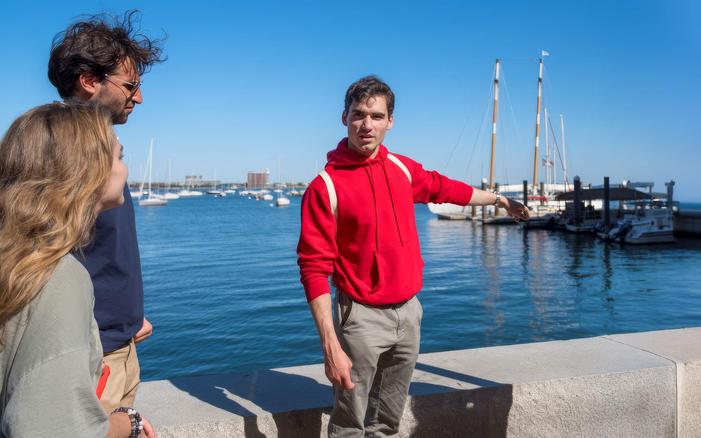 Guide leading a tour group at South Boston Maritime Park with boats in the background.