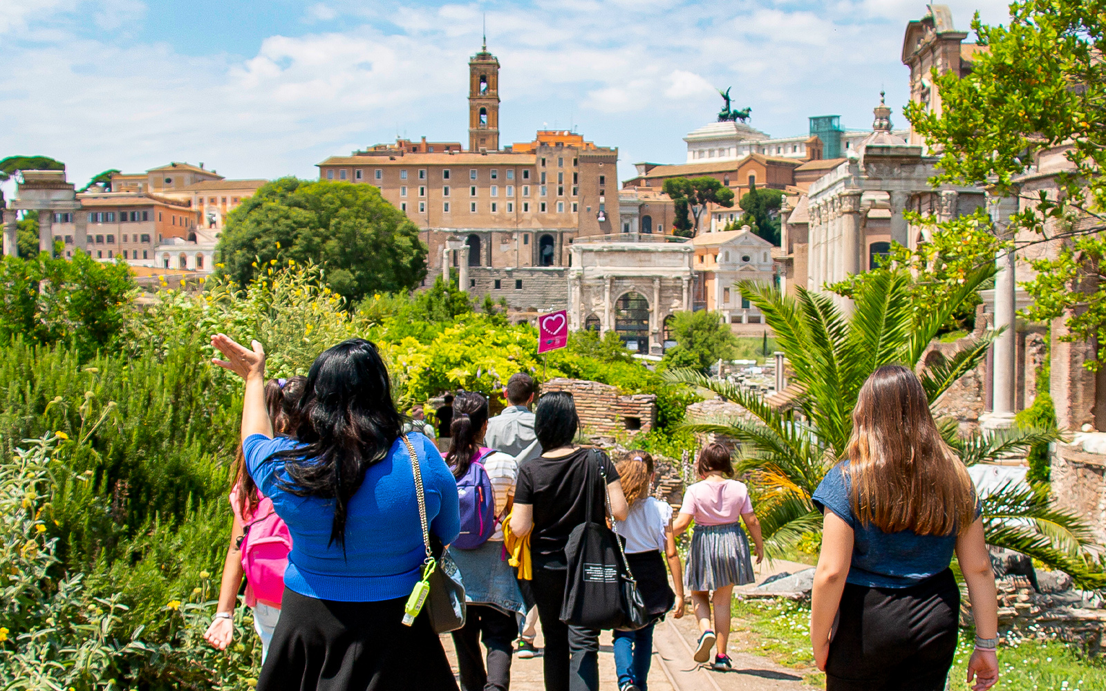 Families exploring the Roman Forum with a guide during the Gladiator Tour in Rome.